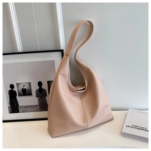 Detail shot of pink beige lychee grain leather texture on the hobo shoulder bag