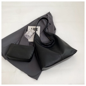 Detail of black lychee grain leather tote bag set including a small inner pouch