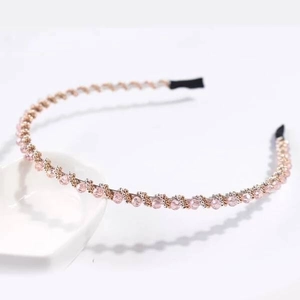 Close-up of pink beaded crystal headband with metallic woven details and anti-slip tips