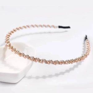 Detail of crystal beaded headband with champagne faceted stones on rose gold metal frame