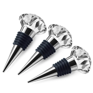Three elegant crystal diamond top wine bottle stoppers with metal base on white background