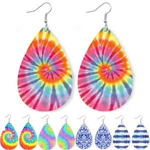 Detailed view of colorful teardrop leather earrings with artistic tie-dye spiral patterns
