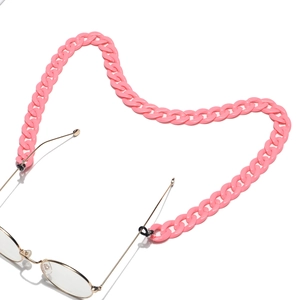 Detailed view of pink acrylic chain links on gold glasses frames with non-slip loops