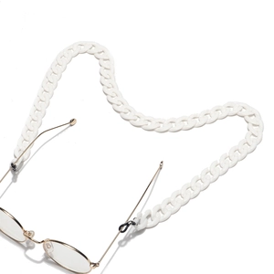 Detailed view of chunky white acrylic eyewear chain with black rubber connectors