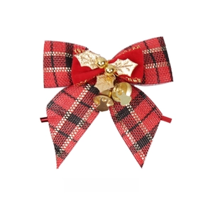 Close-up of red plaid faux linen bow with velvet accents, gold leaves, and small bells