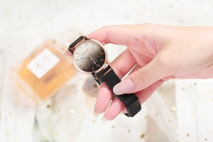 Close-up of women's quartz watch with floral dial and rose gold magnetic mesh band