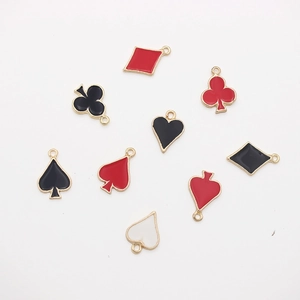 Detail of playing card suit charms in red and black enamel with gold-tone borders