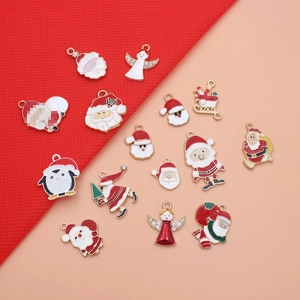 Macro detail of alloy Christmas charms with red drip oil finish and white rhinestones