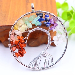 Macro detail of Tree of Life pendant with colorful natural stones and silver wire wrap