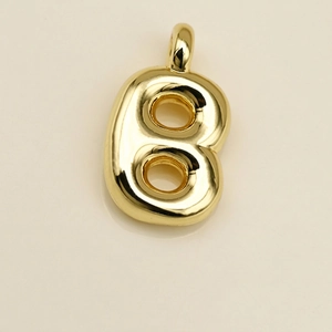 Close-up of a polished golden 3D puff letter B pendant with a high-shine mirror finish
