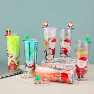 Close-up of colorful Christmas themed plastic straw cups with festive cartoon characters
