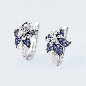 Elegant floral mandala drop earrings with blue and clear gems in silver finish