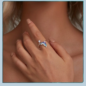 Macro detail of silver mermaid tail ring with gradient scales and opal stone