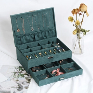 Detail of dark green velvet jewelry box showing double layers and multiple compartments