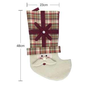 Classic red plaid Christmas stocking with Santa Claus face and festive snowflake pattern