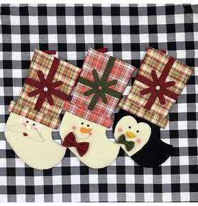 Christmas stockings featuring Santa, Snowman, and Penguin with red and green plaid detail