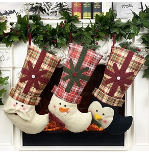 Detailed view of Christmas stockings with Santa, Snowman and Penguin on fireplace