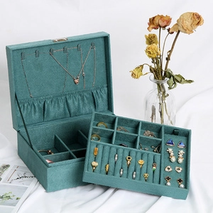 Deep green velvet jewelry box with double layers and necklace hooks detail view