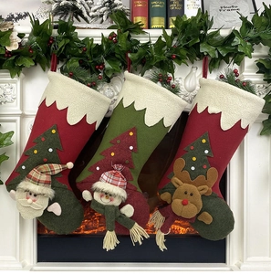 Three festive Christmas stockings with Santa, Snowman and Reindeer on a white fireplace