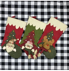 Three festive Christmas stockings featuring 3D Santa, Snowman, and Reindeer plush characters