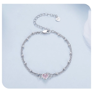 Macro detail of S925 sterling silver stamp on double-layer pink heart stone bracelet