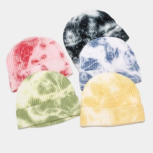 Tie-dye ribbed knit beanies in multiple colors including pink, green, and navy blue