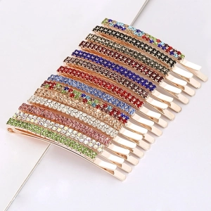 Macro shot of colorful rhinestone hairpins set in green pink and silver plating