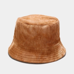Detail of light brown corduroy bucket hat texture and soft fabric on white background