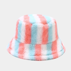 Detail of plush rainbow bucket hat showing soft faux fur texture and pastel stripes