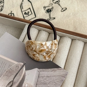 Detail of high-elastic hair tie with elegant beige marble acetate crescent charm