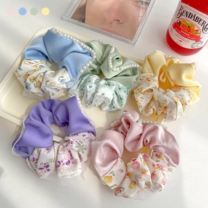Pastel floral patchwork scrunchies with white pearl beads in a stylish display tray