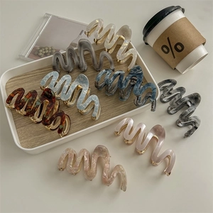 Elegant marble pattern acetate hair claws with gold metal teeth in various colors