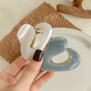 Minimalist acetate hair claw clips in white and grey colors with gold metal springs