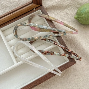 Three U-shaped acetate hair pins in pink gradient, tortoiseshell, and white pearl finish
