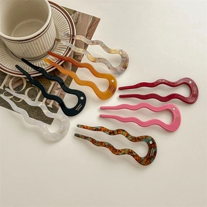 U-shaped acetate hair pins in various colors with rhinestone accents and wavy design