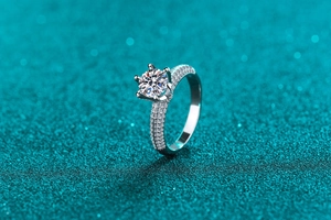 Macro detail of S925 sterling silver ring with moissanite center stone and pavé band