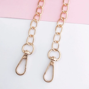Detail of 110cm gold metal chain strap featuring dual lobster clasps for crossbody bags