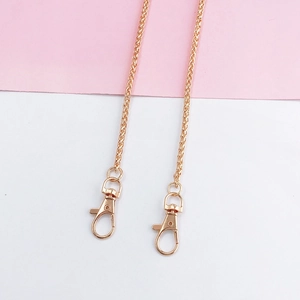 Close-up of rose gold wheat chain with lobster clasps for bags and phone cases
