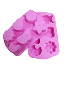 Detail of pink silicone coaster molds with heart, star, butterfly, and flower patterns