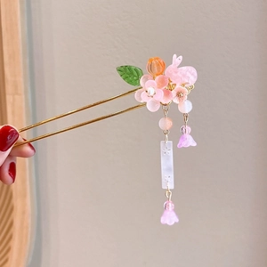 Close-up of pink rabbit hair stick with floral tassels and jade-like pendants