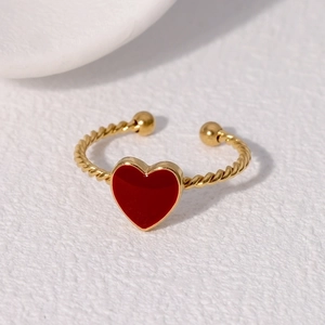 Minimalist gold rope band ring with red heart pendant shown from a 45-degree angle view