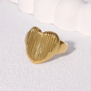 Minimalist gold heart ring with vertical textured surface on white background