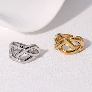 Detail of twisted woven design on adjustable stainless steel rings in gold and silver