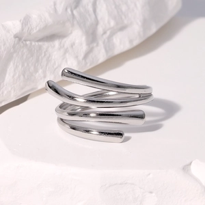 Macro shot of silver multi-layer spiral ring with minimalist metallic finish on stone