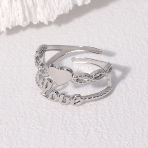 Close-up of silver heart-shaped double-layer open ring with Love engraving
