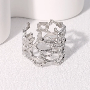 Detailed macro shot of irregular hollow branch design on silver stainless steel ring