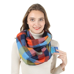 Detail of soft plaid neck warmer featuring a practical pocket for storing a smartphone