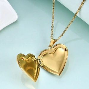 Golden heart-shaped locket necklace shown open for photos with minimalist steel chain