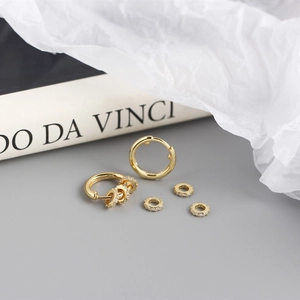 Macro shot of detachable gold S925 silver hoop earrings with sparkling zirconia rings