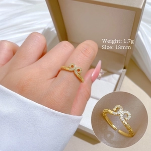Adjustable golden hollow ring featuring a minimalist design on a silk background